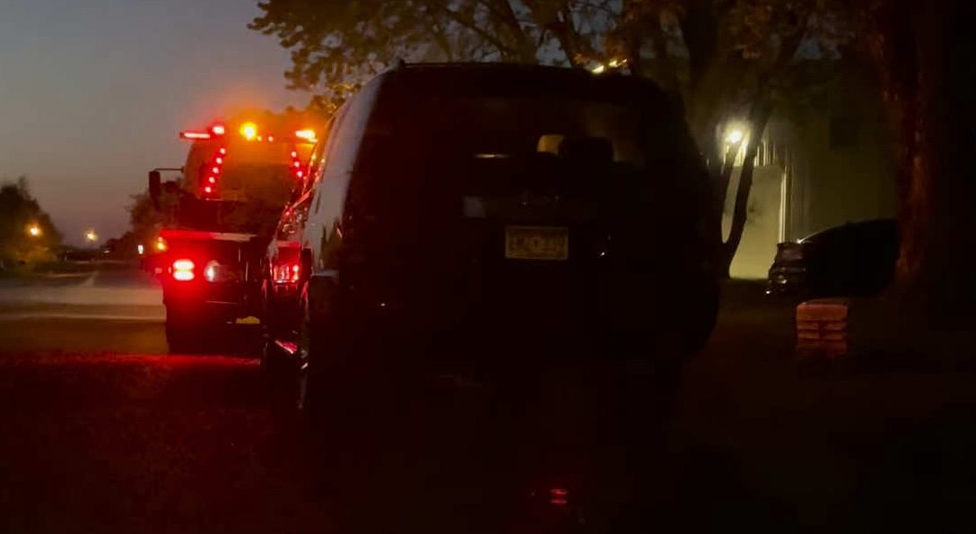 Tow truck with warning lights at night