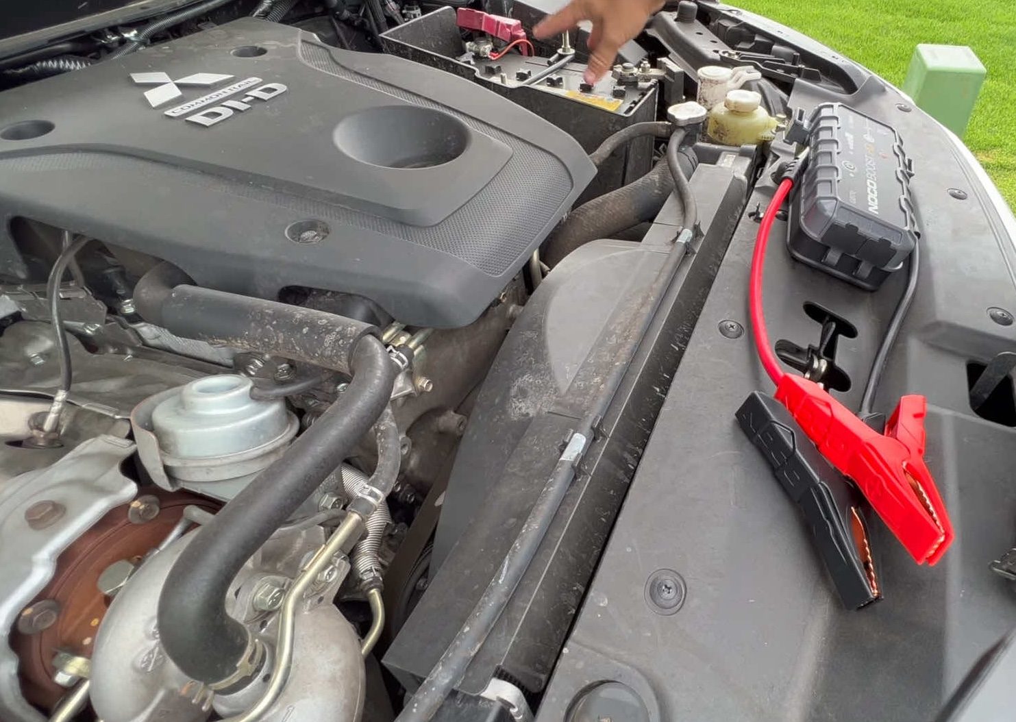 Jumper clamps connected to a car battery