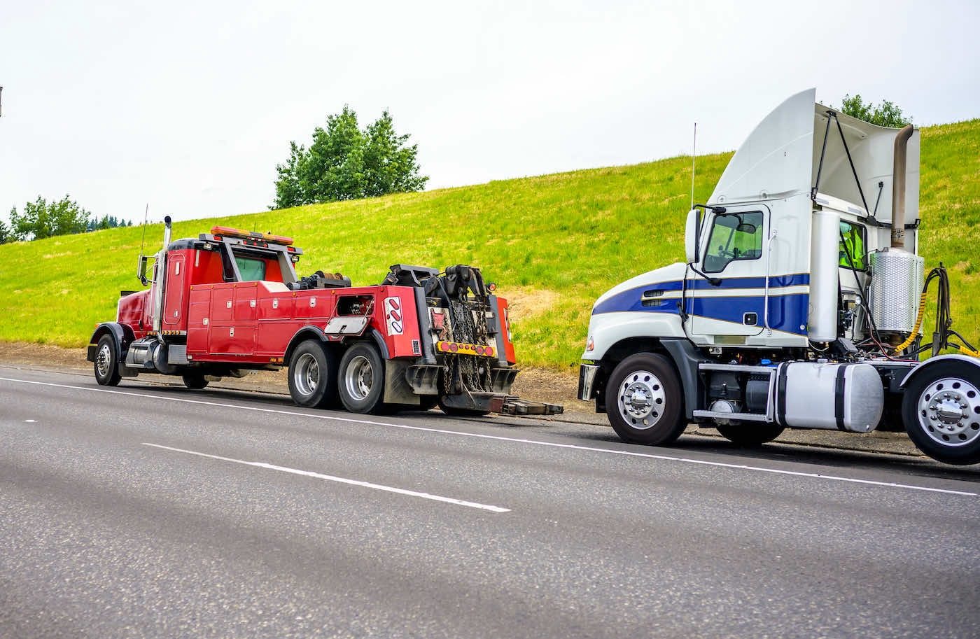 Heavy wrecker towing a semi truck cab